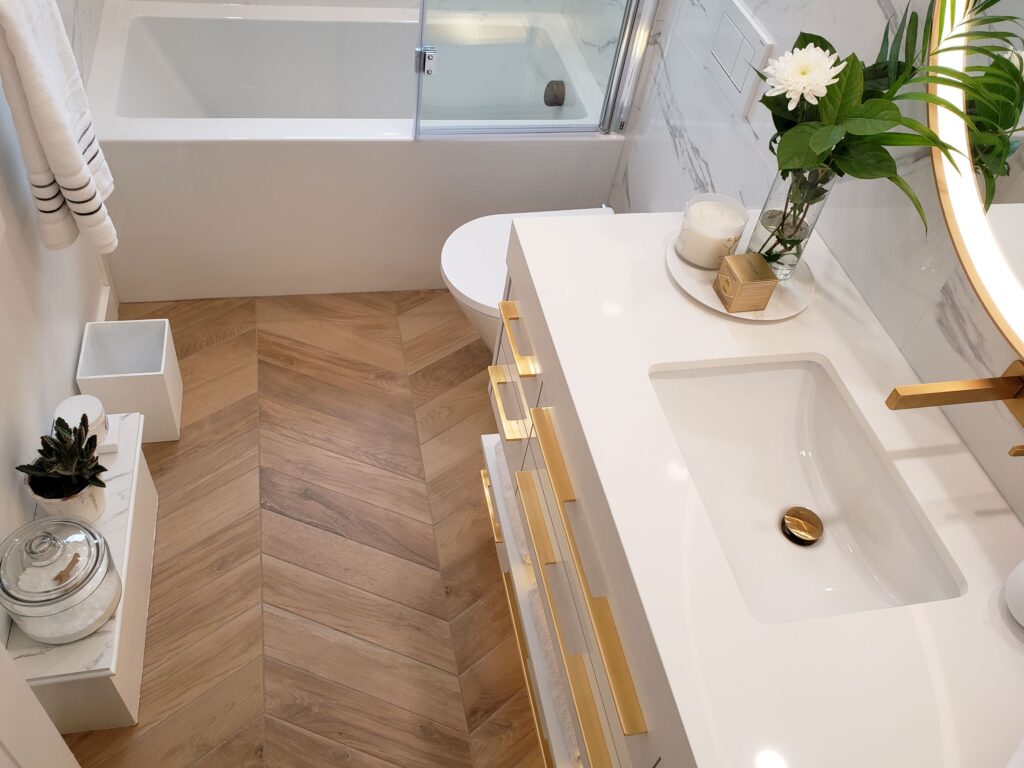 chevron-laid wood look floors add warmth to the white colour palatte