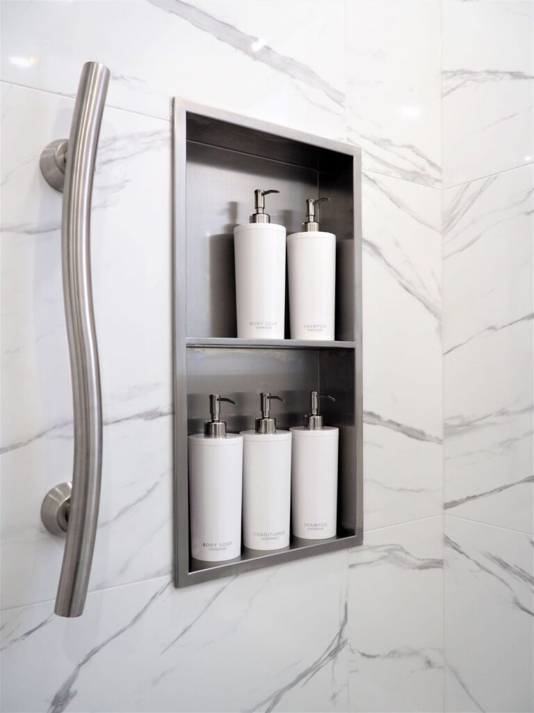 Stainless Steel Niche organizes toiletries and a grab bar ensures safety 